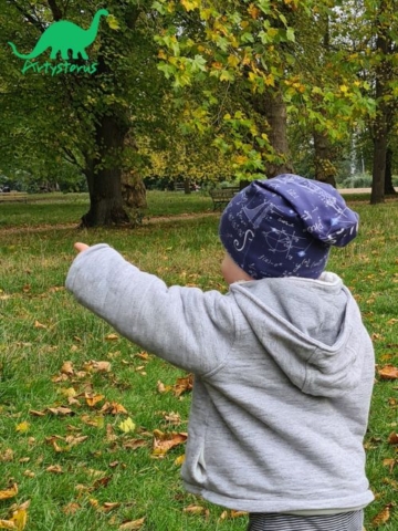 Child outside wearing blue Space Maths fabric slouch beanie hat