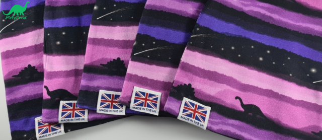 Various sizes of slouch beanie hats in purple dinosaur fabric