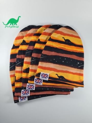 Various sizes of slouch beanie hats in sunset dinosaur fabric