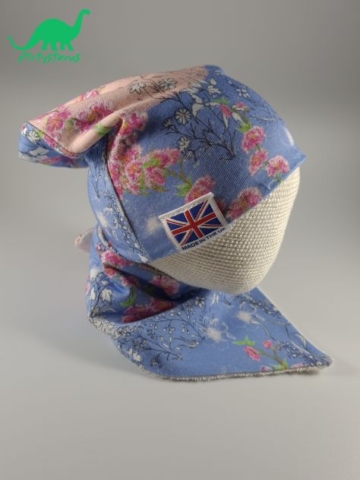 Floral slouch beanie hat and bib on crocheted baby head