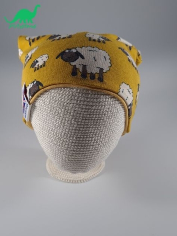 Ochre sheep fabric slouch beanie hat on crocheted baby head